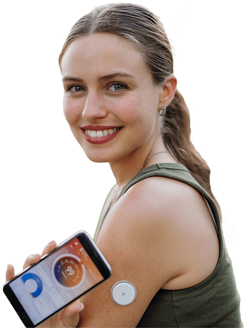 Young, smiling woman showing Continuous Glucose Monitor.